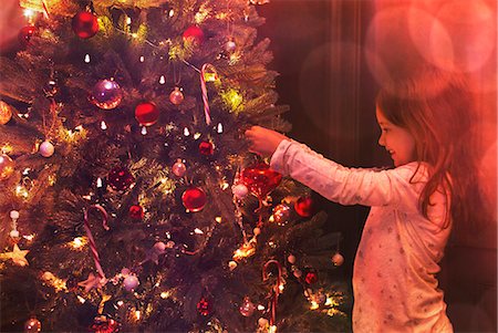 simsearch:6124-08926935,k - Girl decorating Christmas tree Stock Photo - Premium Royalty-Free, Code: 6113-08659545