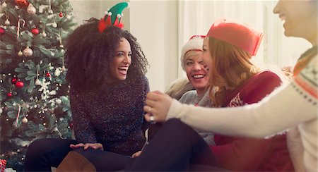 simsearch:6113-08659567,k - Friends talking and laughing near Christmas tree Stock Photo - Premium Royalty-Free, Code: 6113-08659552