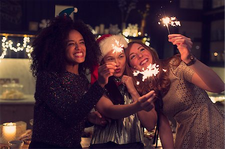 simsearch:6113-08659620,k - Playful young women with sparklers Photographie de stock - Premium Libres de Droits, Code: 6113-08659557