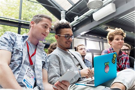 sticker - Men using laptop in audience at conference Stock Photo - Premium Royalty-Free, Code: 6113-08698044