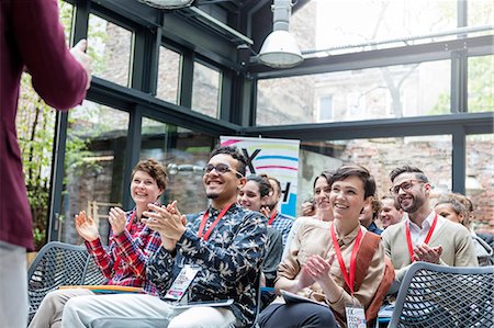 simsearch:6113-09131163,k - Smiling audience clapping for speaker at conference Photographie de stock - Premium Libres de Droits, Code: 6113-08698050