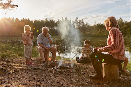 estanque - Grandparents and grandchildren enjoying campfire at sunny lakeside Foto de stock - Sin royalties Premium, Código: 6113-08698080