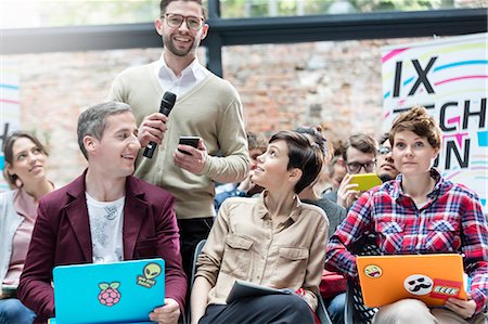 simsearch:6113-08698036,k - Man in audience asking question with microphone at technology conference Stock Photo - Premium Royalty-Free, Code: 6113-08698014