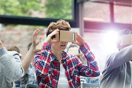 Young woman trying virtual reality simulator glasses at technology conference Stock Photo - Premium Royalty-Free, Code: 6113-08698029