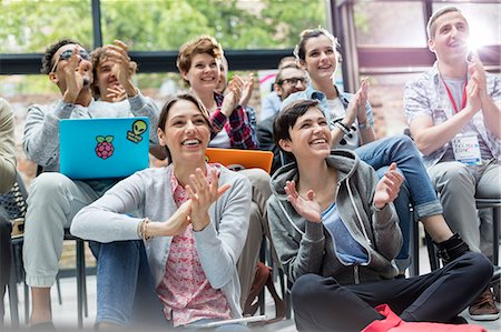 simsearch:6113-08698001,k - Smiling audience clapping at technology conference Photographie de stock - Premium Libres de Droits, Code: 6113-08698035