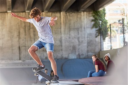 Teenage boy doing skateboard stunt at skate park Photographie de stock - Premium Libres de Droits, Code: 6113-08698240