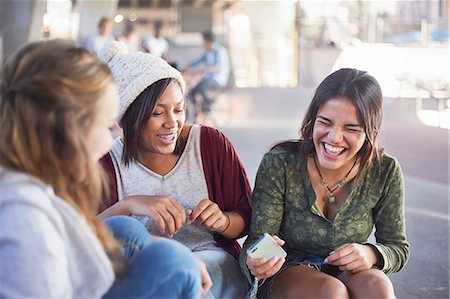 simsearch:6113-07159968,k - Teenage girls with cell phone laughing and hanging out Stock Photo - Premium Royalty-Free, Code: 6113-08698209