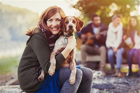 simsearch:6113-06720860,k - Portrait smiling woman hugging dog at campsite with friends Stockbilder - Premium RF Lizenzfrei, Bildnummer: 6113-08743442