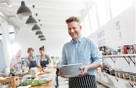 simsearch:6113-08743631,k - Portrait smiling man in cooking class kitchen Stock Photo - Premium Royalty-Free, Code: 6113-08743631