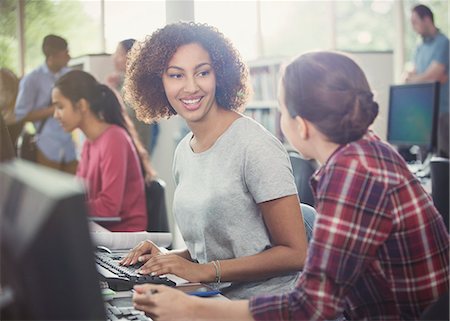 simsearch:6113-08321440,k - Female college students using computers in computer lab library Stock Photo - Premium Royalty-Free, Code: 6113-08769640