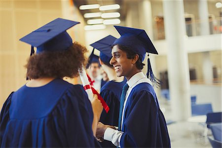 simsearch:6113-07791485,k - Smiling college graduates in cap and gown Stock Photo - Premium Royalty-Free, Code: 6113-08769653