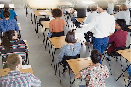 Professor collecting test from students in classroom Photographie de stock - Premium Libres de Droits, Code: 6113-08769674