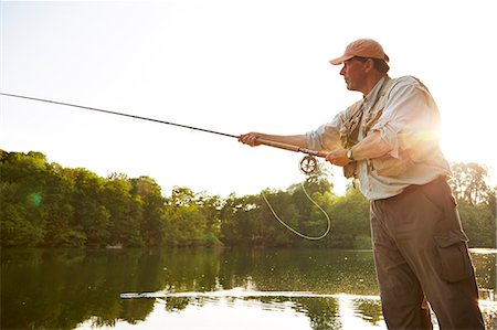 Senior man fly fishing at summer lake Foto de stock - Sin royalties Premium, Código: 6113-08769774