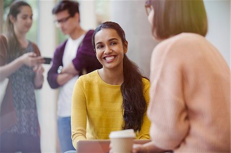 simsearch:630-06724589,k - Smiling female college students drinking coffee and talking Stock Photo - Premium Royalty-Free, Code: 6113-08769711