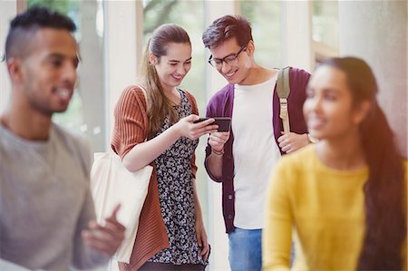 peruvian woman - College students texting with cell phone Stock Photo - Premium Royalty-Free, Code: 6113-08769716