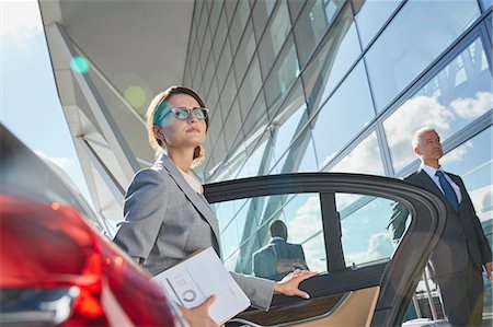 simsearch:6124-08907966,k - Businesswoman arriving at airport getting out of town car Stock Photo - Premium Royalty-Free, Code: 6113-08784291