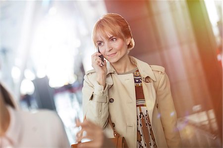 simsearch:6113-07906343,k - Businesswoman talking on cell phone in airport Stock Photo - Premium Royalty-Free, Code: 6113-08784203