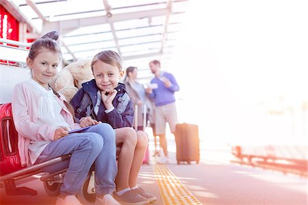 simsearch:6113-08784260,k - Portrait smiling brother and sister waiting outside airport Stock Photo - Premium Royalty-Free, Code: 6113-08784213