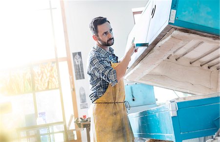 stained glass craftsman - Stained glass artist using kiln in studio Stock Photo - Premium Royalty-Free, Code: 6113-08784341