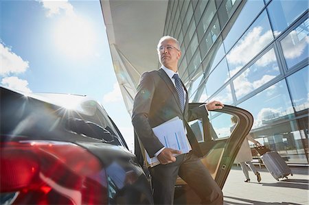 simsearch:6124-08907966,k - Businessman arriving at airport getting out of town car Stock Photo - Premium Royalty-Free, Code: 6113-08784311