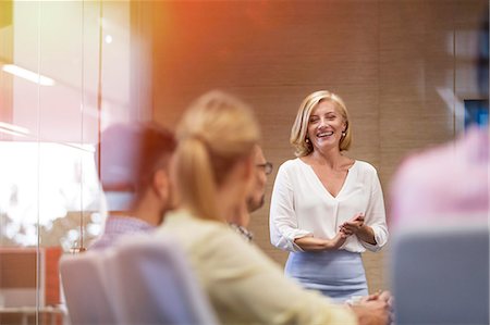 Smiling businesswoman leading meeting in conference room Stock Photo - Premium Royalty-Free, Code: 6113-08784449