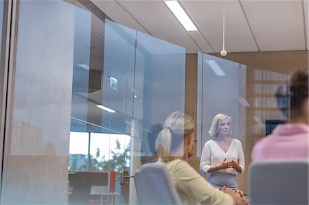 Businesswoman leading meeting in conference room Stock Photo - Premium Royalty-Free, Code: 6113-08784463