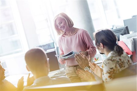 simsearch:6113-08943778,k - Business people clapping for businesswoman leading meeting in office Photographie de stock - Premium Libres de Droits, Code: 6113-08784504