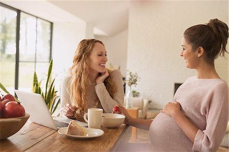 people eating desserts - Pregnant women eating cake and fruit at laptop in dining room Stock Photo - Premium Royalty-Free, Code: 6113-08721979