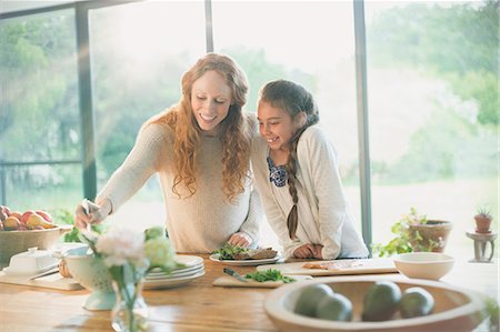 dinner kids - Smiling mother and daughter preparing food Stock Photo - Premium Royalty-Free, Code: 6113-08722040