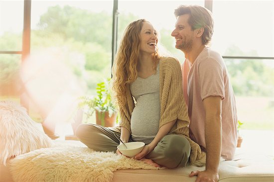 Smiling pregnant couple eating and talking Stock Photo - Premium Royalty-Free, Image code: 6113-08722083