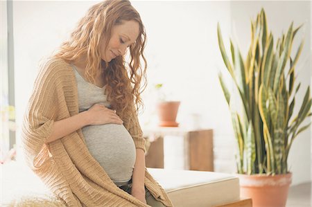 Pregnant woman holding stomach Stock Photo - Premium Royalty-Free, Code: 6113-08722085