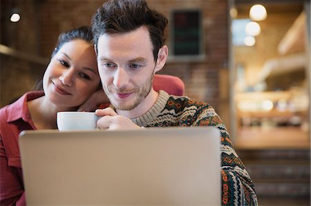 simsearch:6113-06753237,k - Couple drinking coffee and using laptop in cafe Stock Photo - Premium Royalty-Free, Code: 6113-08722192