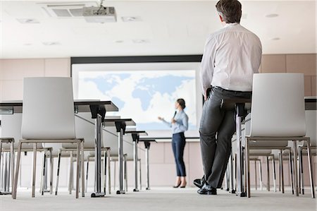 screen - Businessman watching businesswoman leading presentation at projection screen in conference room Stock Photo - Premium Royalty-Free, Code: 6113-08722123