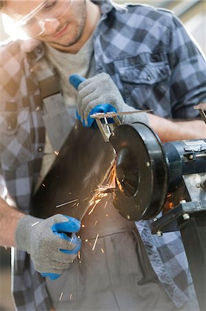 simsearch:6113-08722276,k - Metal worker using sander in workshop Stock Photo - Premium Royalty-Free, Code: 6113-08722264