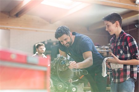 simsearch:649-08118274,k - Father and son rebuilding car engine in auto repair shop Stock Photo - Premium Royalty-Free, Code: 6113-08722271