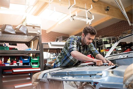 Mechanic fixing car engine in auto repair shop Stock Photo - Premium Royalty-Free, Code: 6113-08722280