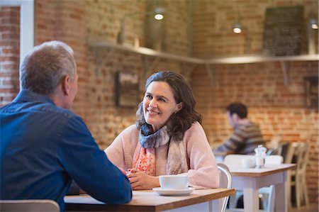 Smiling couple talking in cafe Stock Photo - Premium Royalty-Free, Code: 6113-08722207