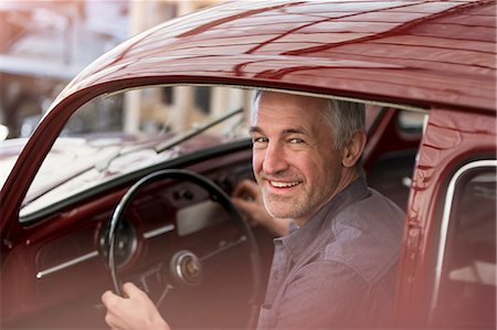 simsearch:6113-08722230,k - Portrait smiling mechanic inside classic car Stock Photo - Premium Royalty-Free, Code: 6113-08722223