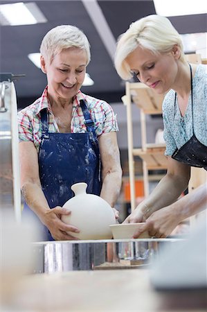 people working at crafts - Women placing pottery in kiln in studio Stock Photo - Premium Royalty-Free, Code: 6113-08722397