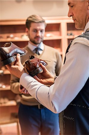 simsearch:6113-08722332,k - Businessman shopping for dress shoes in menswear shop Stock Photo - Premium Royalty-Free, Code: 6113-08722319