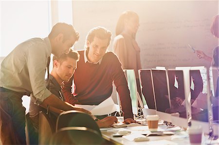 rows - Businessmen reading and discussing paperwork in office Stock Photo - Premium Royalty-Free, Code: 6113-08882400