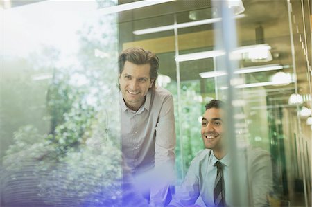 simsearch:6113-06908973,k - Smiling businessmen in conference room meeting Stock Photo - Premium Royalty-Free, Code: 6113-08882414