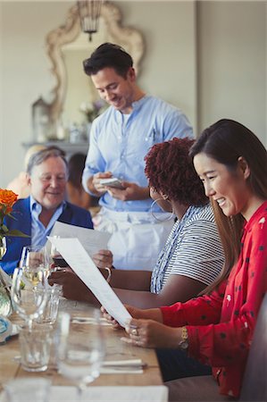 simsearch:6113-08882683,k - Waiter taking order of friends at restaurant table with menu Foto de stock - Sin royalties Premium, Código: 6113-08882560