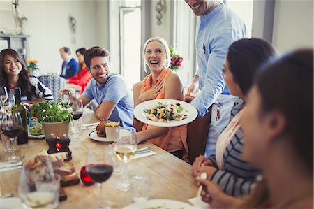 simsearch:6113-08805344,k - Waiter serving salad to woman dining with friends at restaurant table Stock Photo - Premium Royalty-Free, Code: 6113-08882562