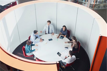 simsearch:6113-06908888,k - Business people meeting in round open plan conference room Photographie de stock - Premium Libres de Droits, Code: 6113-08882502