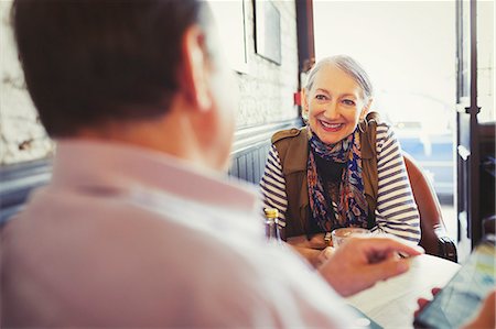 simsearch:6113-09131719,k - Senior couple talking and using smart phone in cafe Stock Photo - Premium Royalty-Free, Code: 6113-08882646