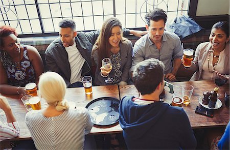 simsearch:6102-08882259,k - Overhead view of friends drinking beer and wine at table in bar Photographie de stock - Premium Libres de Droits, Code: 6113-08882661