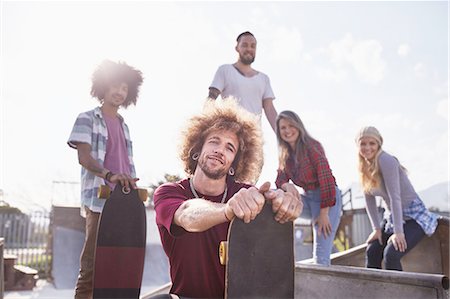 simsearch:6113-08882733,k - Portrait cool friends with skateboards at sunny skate park Stock Photo - Premium Royalty-Free, Code: 6113-08882694
