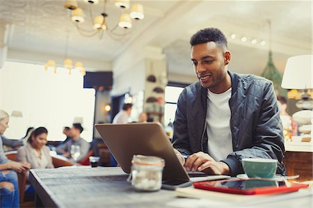 simsearch:6113-07543487,k - Creative businessman working at laptop in cafe Stock Photo - Premium Royalty-Free, Code: 6113-08882617