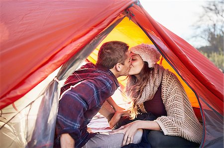 simsearch:6113-09027854,k - Young couple camping, kissing inside tent Stock Photo - Premium Royalty-Free, Code: 6113-08882783